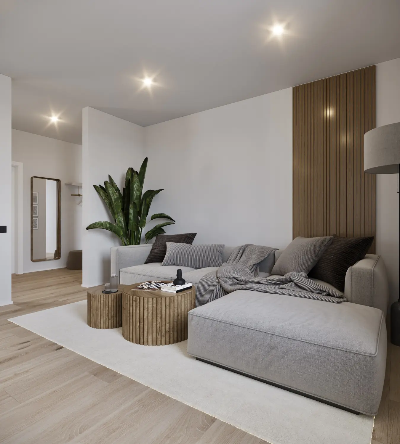 KM Investment Group, Wohnzimmer mit grauer Couch und Dekorationspflanzen